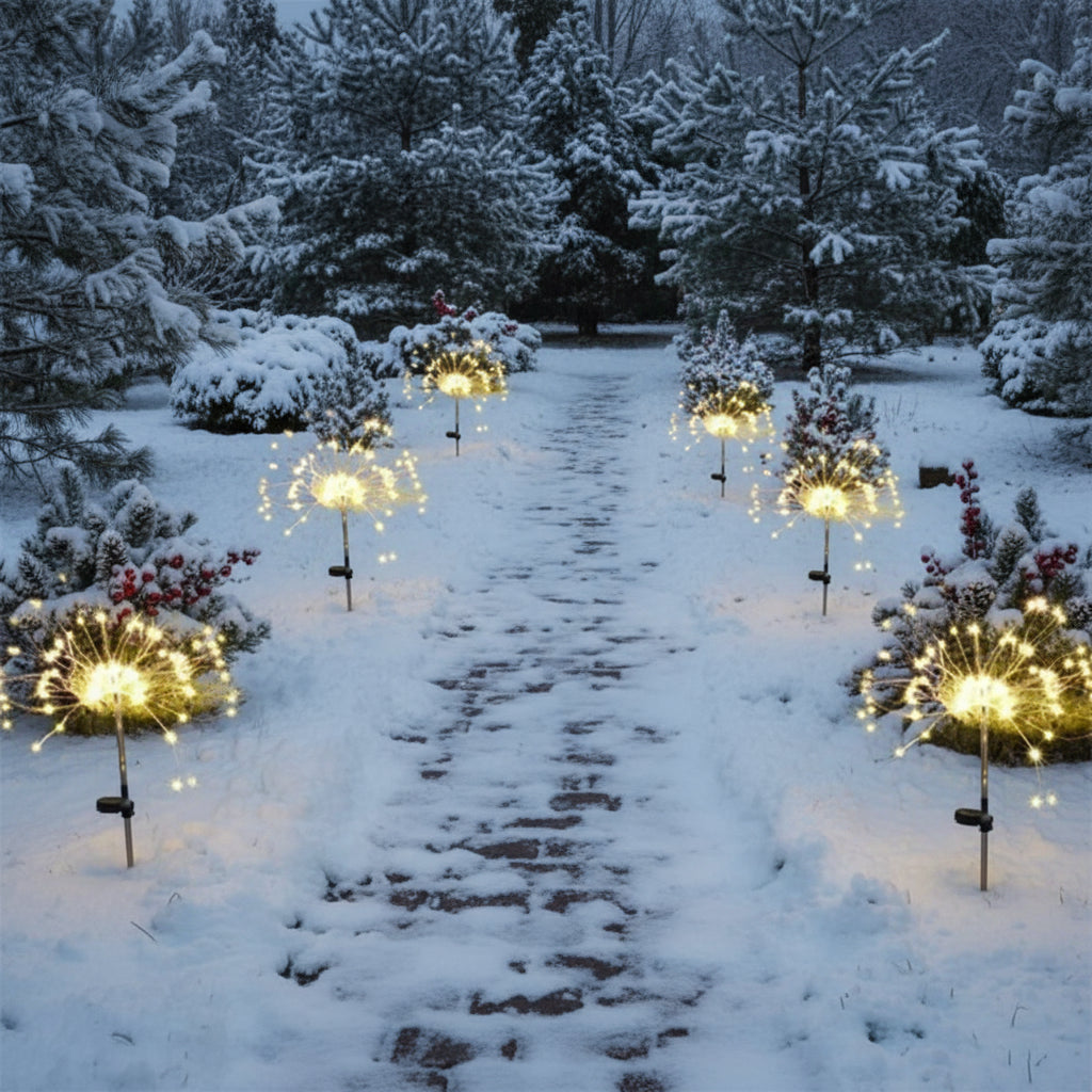 Warmweisse Solar-Lichtbüschel entlang eines verschneiten Gartenwegs