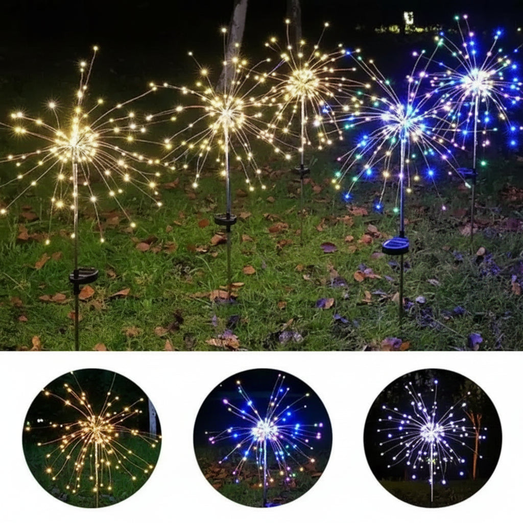 Mehrere Feuerwerkslichter in Warmweiss, Blau und Weiss im nächtlichen Rasen