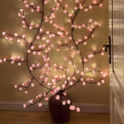 LED Kirschblütenzweig aus einer dunklen Bodenvase an der Wand ausgebreitet